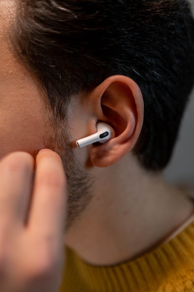 Detailed close-up of a person wearing Anker Soundcore Life P2 Mini Wireless earbuds, showcasing modern tech use.